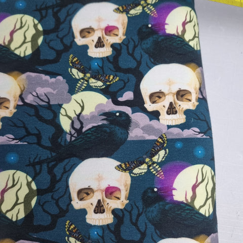 62cm BOLT END. Raven and skull heavyweight jersey fabric