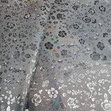 47x44cm BOLT END. Some Crease marks. Matte black with holographic flowers Faux leather / vinyl fabric.