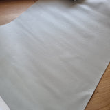 Light grey 40x70cm BOLT END. Faint line in the middle at certain angle.Solid Textured Faux leather / vinyl fabric.